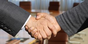 A handshake once you agree with an expert on moving insurance.