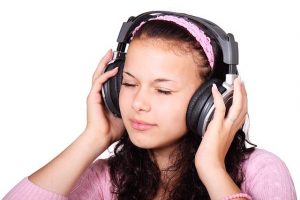 A girl listening to a piece of music.