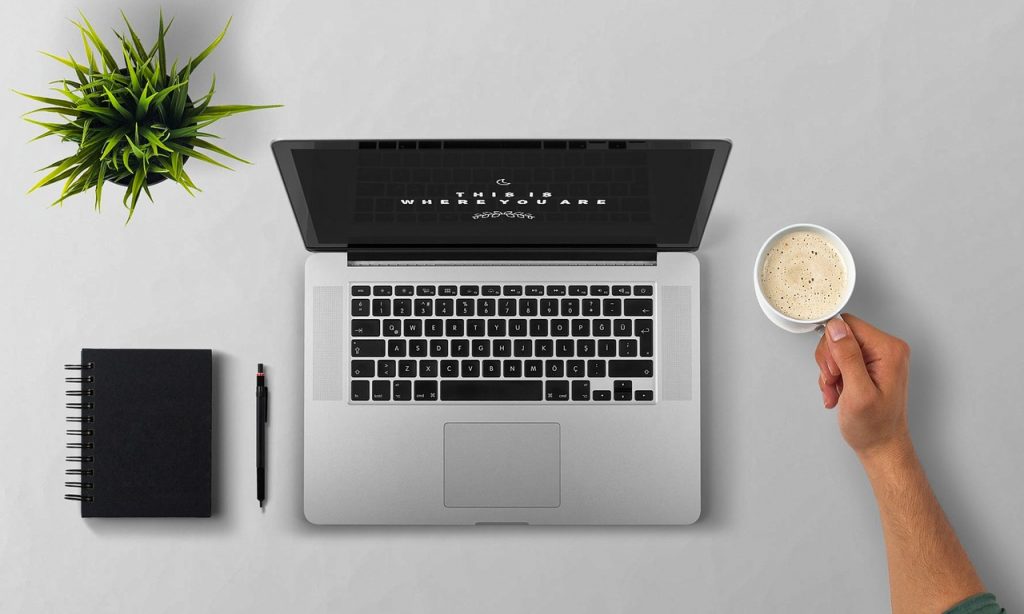 A person sitting at a desk and getting ready for searching for a storage unit online.