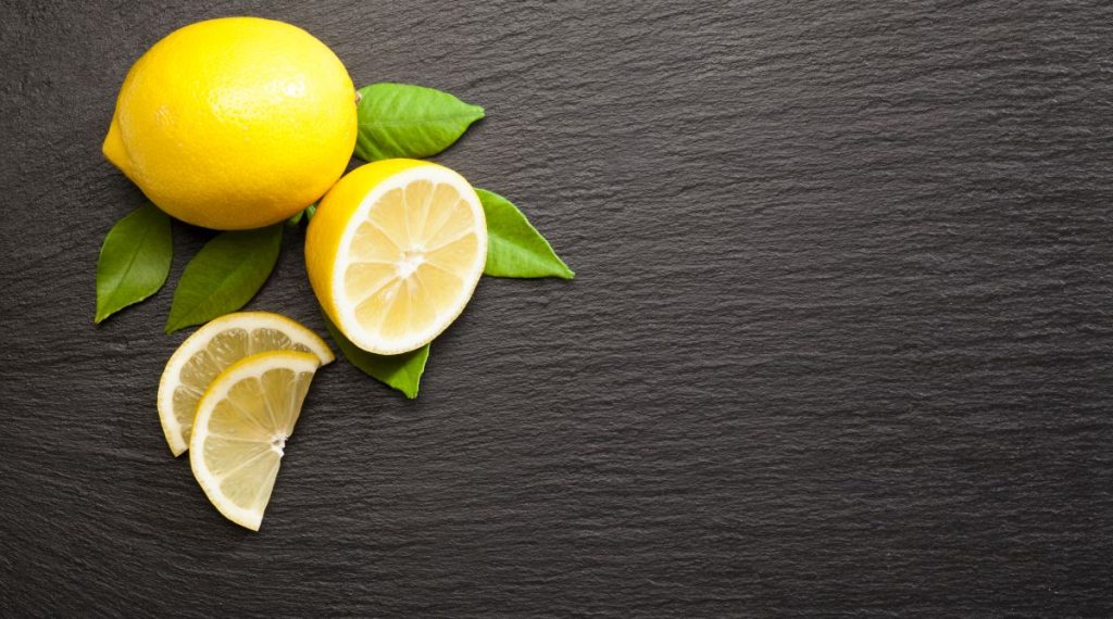 Lemon fruit on black slate background shot directly above