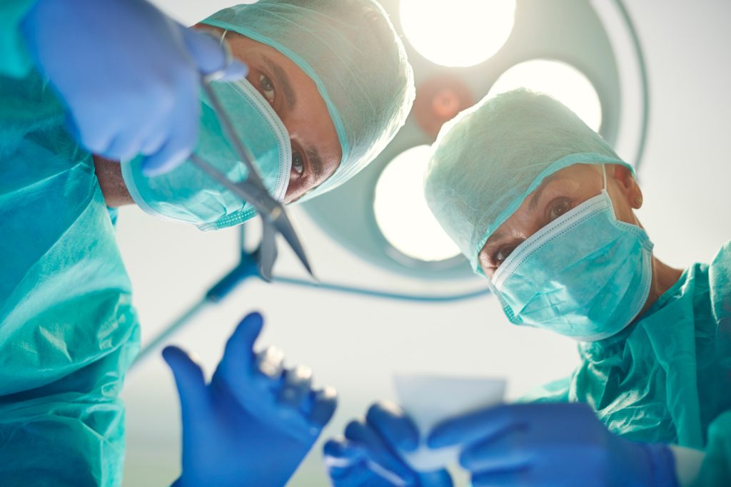 surgeons holding surgical bandage scissors